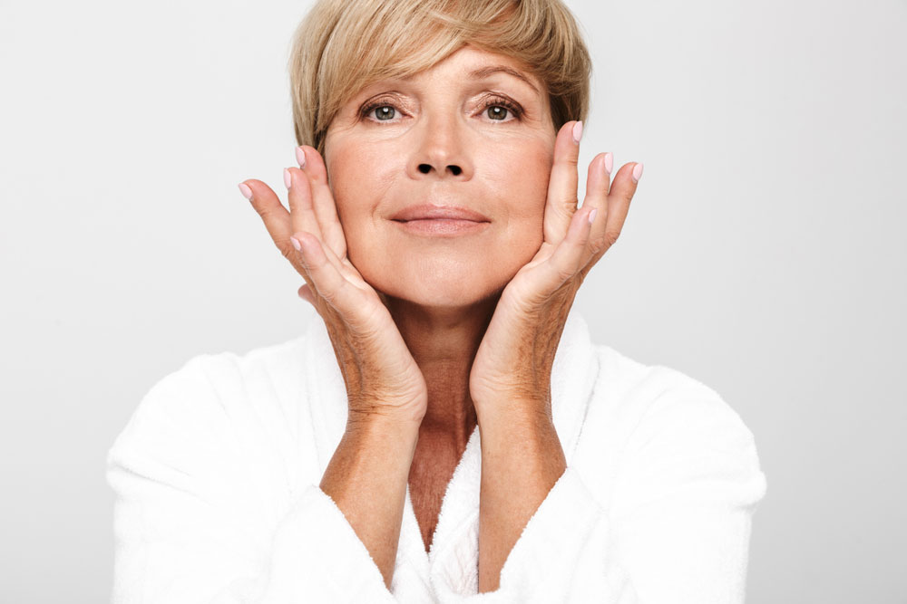 Woman touching face looking into camera